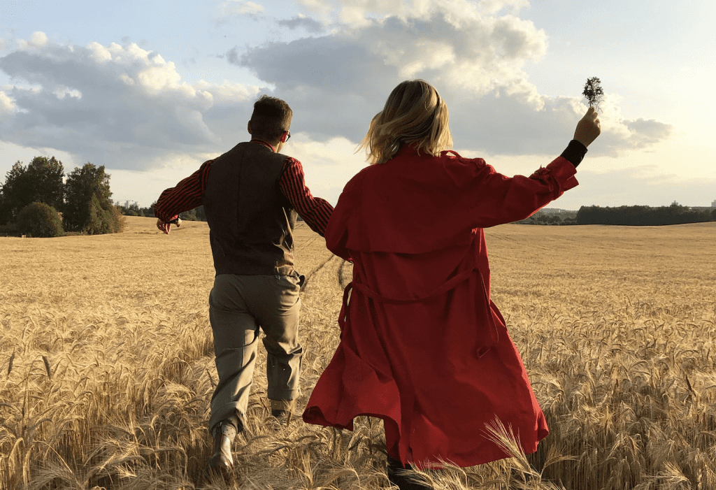 First date, couple running in a field, butterflies and nervous, happy and carefree