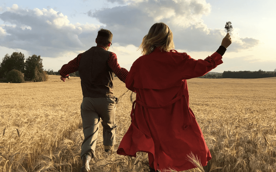 First date, couple running in a field, butterflies and nervous, happy and carefree