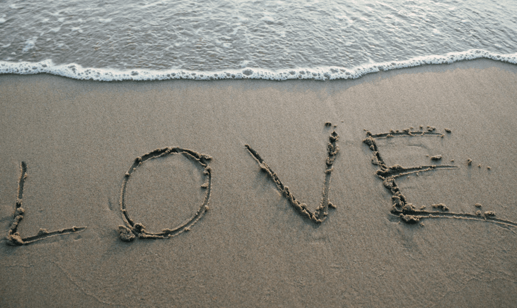 beach with love written in the sand, love bombing blog post