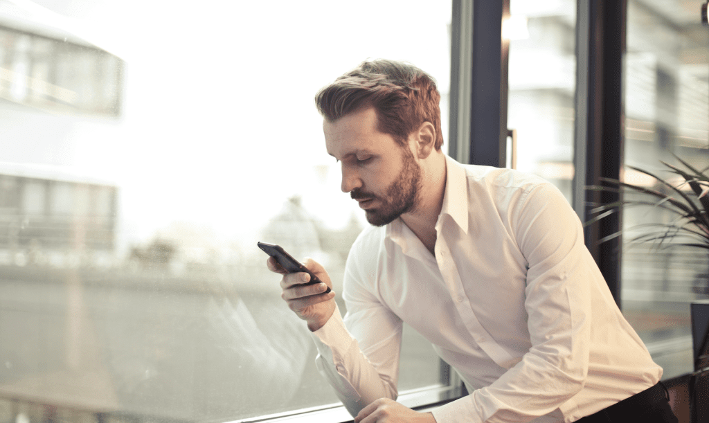 Man looking at phone. Tinder, dating apps