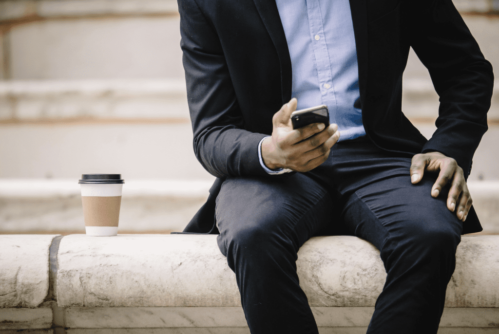 man in suit holding phone, communication in dating
